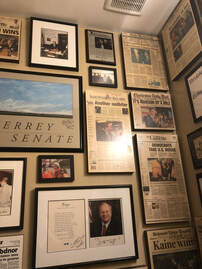 Newspapers and memorabilia hung salon style