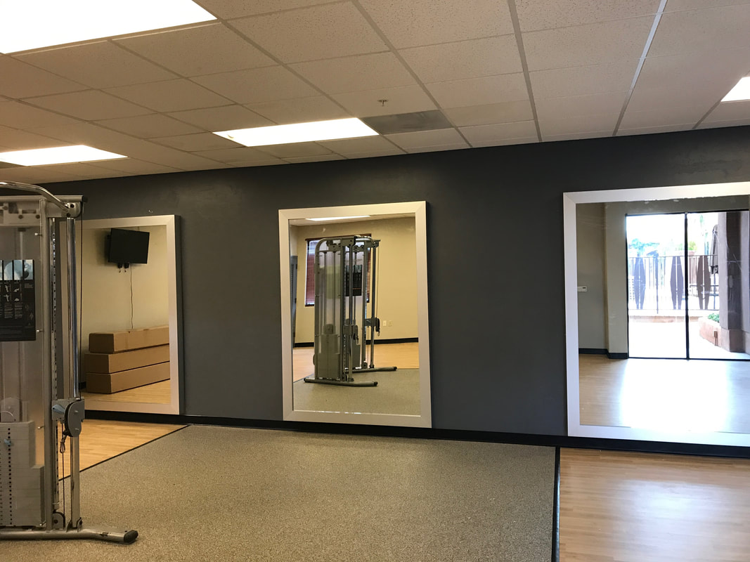 Mirrors hanging in gym at Embassy Suites.